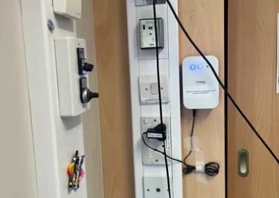 White box sensor next to wall-mounted switches