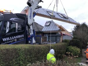 Roof panel being lowered into place