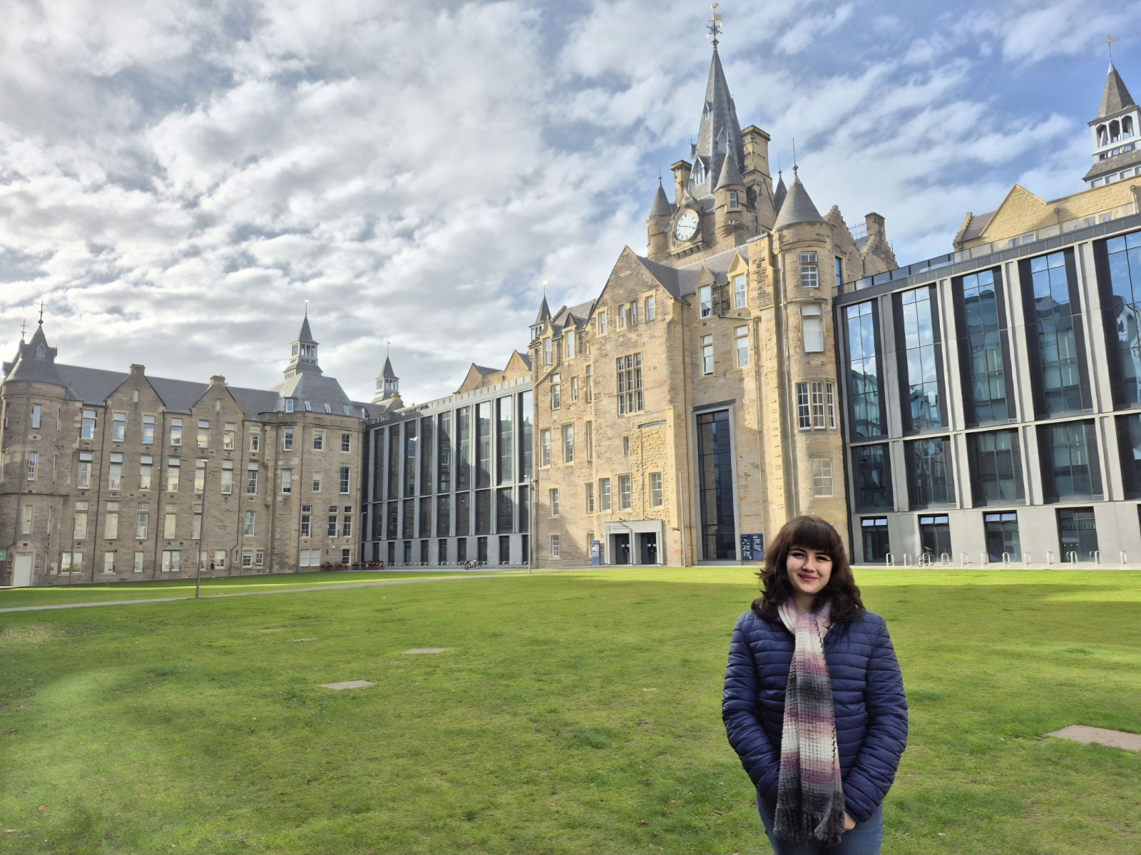 Dr Beste Ozyurt at EFI A young woman, Dr Beste Ozyurt, standing in front of the Edinburgh Futures Institute building