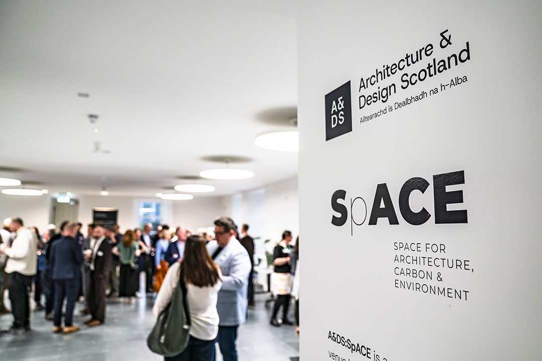 Image of people attending an event, with a banner in the foreground